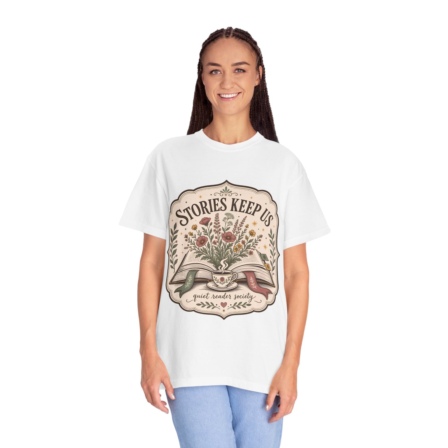 Woman wearing the Stories Keep Us vintage book lover T-shirt in ivory while enjoying a quiet reading moment.
