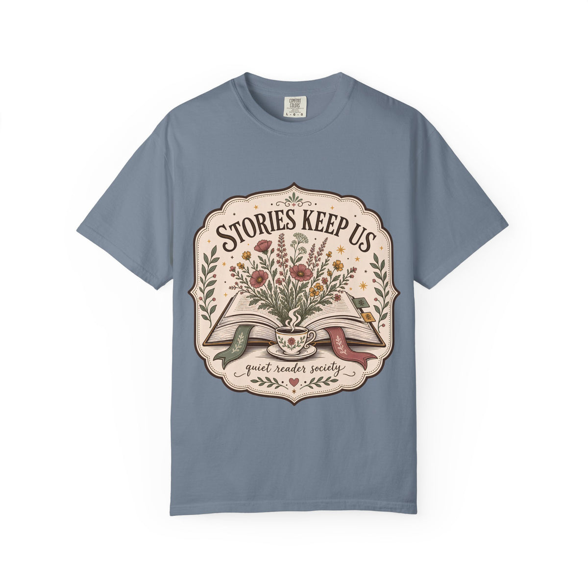 Stories Keep Us Quiet Reader Society shirt in Blue Jean featuring an open book, wildflowers and a floral teacup.