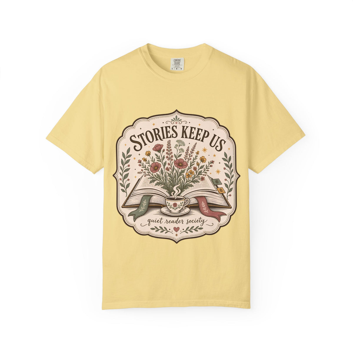 Stories Keep Us Quiet Reader Society shirt in Butter featuring an open book, wildflowers and a floral teacup.