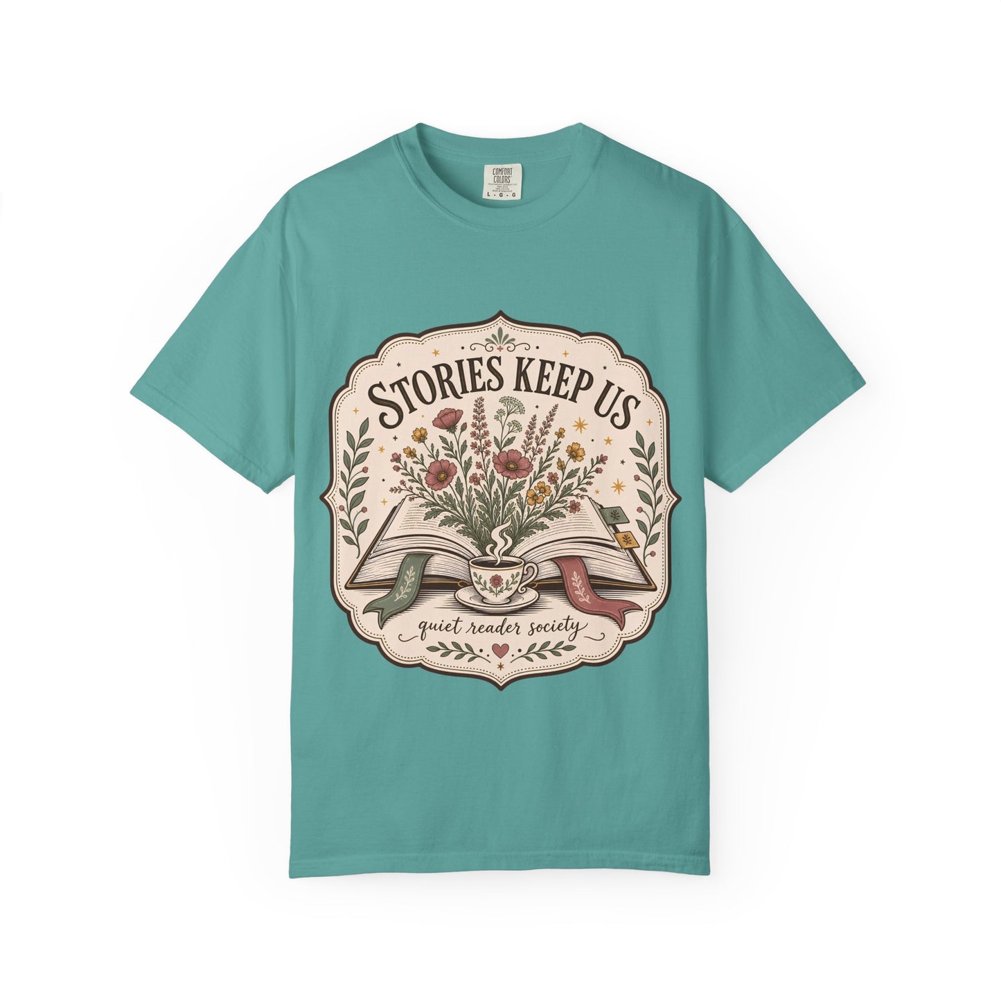 Front view of the Stories Keep Us vintage reading T-shirt in seafoam featuring a floral book-inspired illustration.