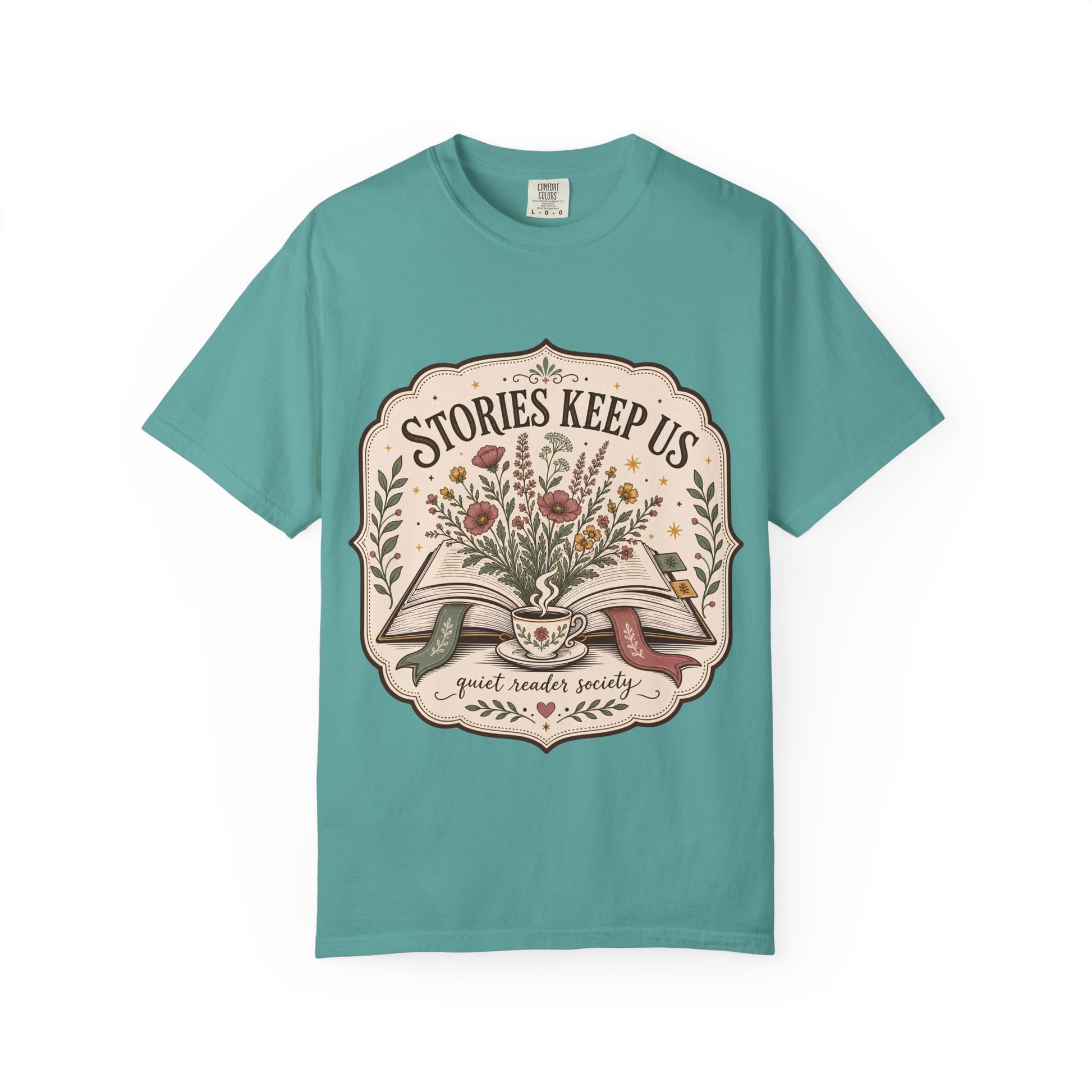 Front view of the Stories Keep Us vintage reading T-shirt in seafoam featuring a floral book-inspired illustration.