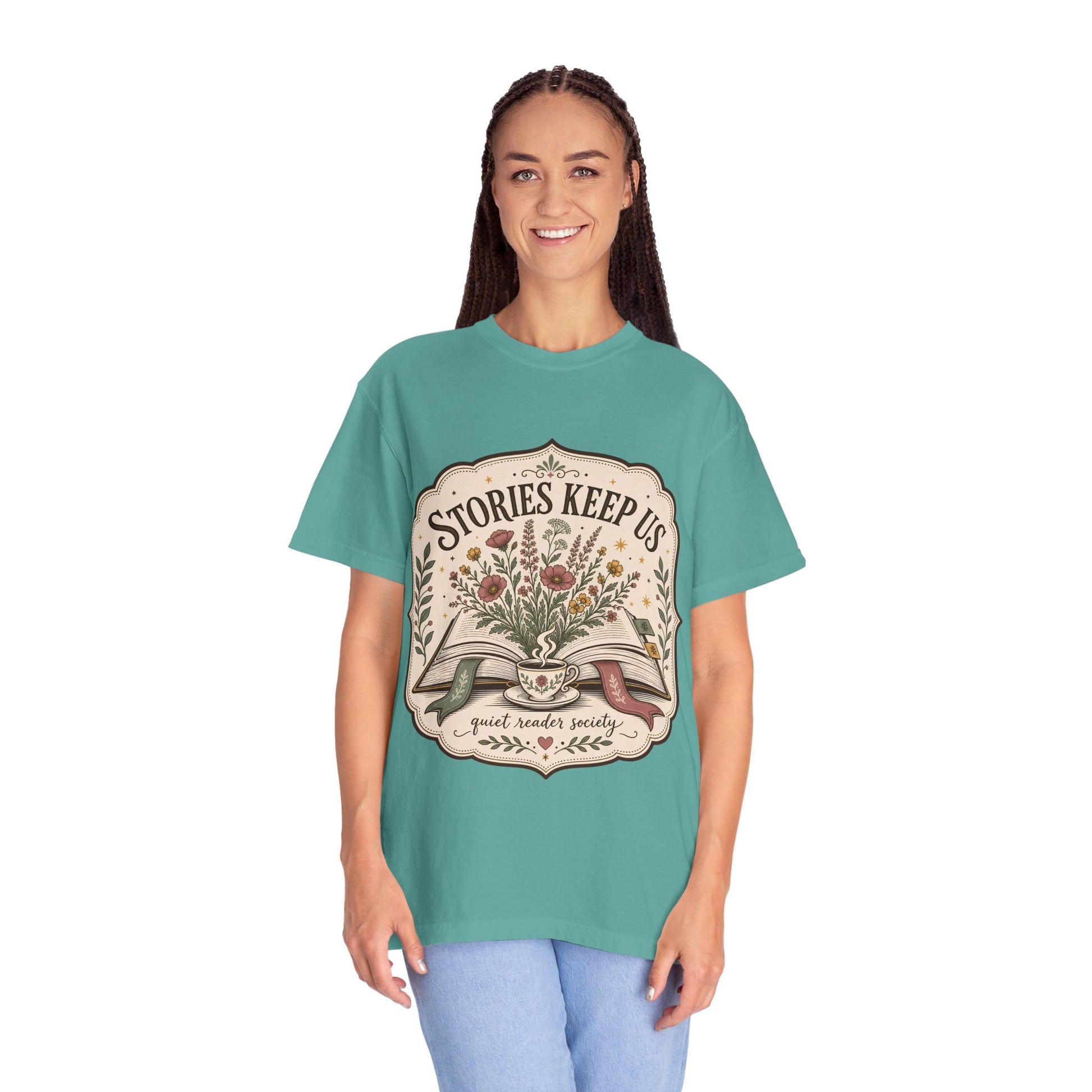 Woman wearing the Stories Keep Us book-inspired graphic T-shirt in seafoam for readers, writers and book lovers.