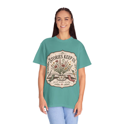 Woman wearing the Stories Keep Us book-inspired graphic T-shirt in seafoam for readers, writers and book lovers.