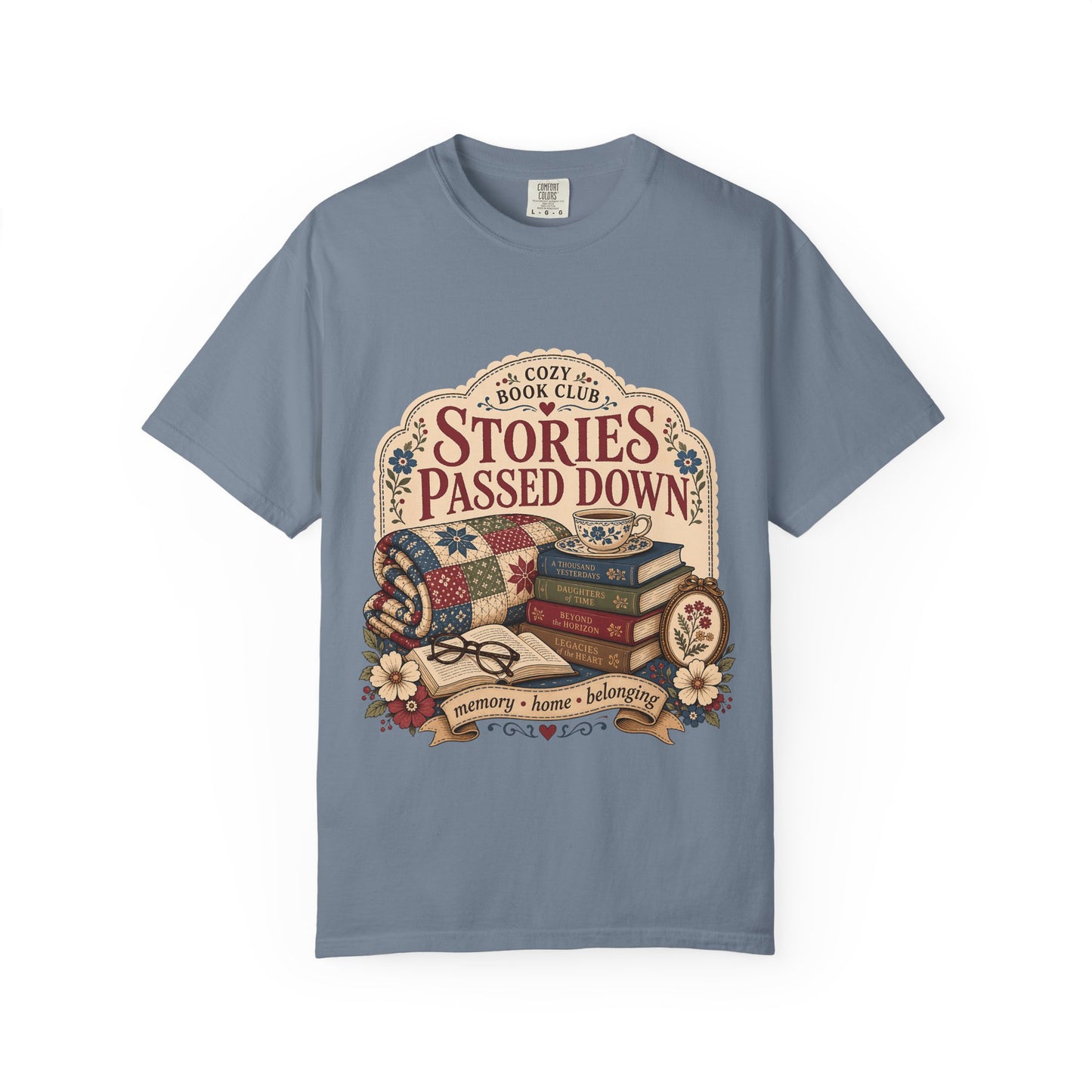 Stories Passed Down literary T-shirt with books, a patchwork quilt and floral keepsakes on Blue Jean.