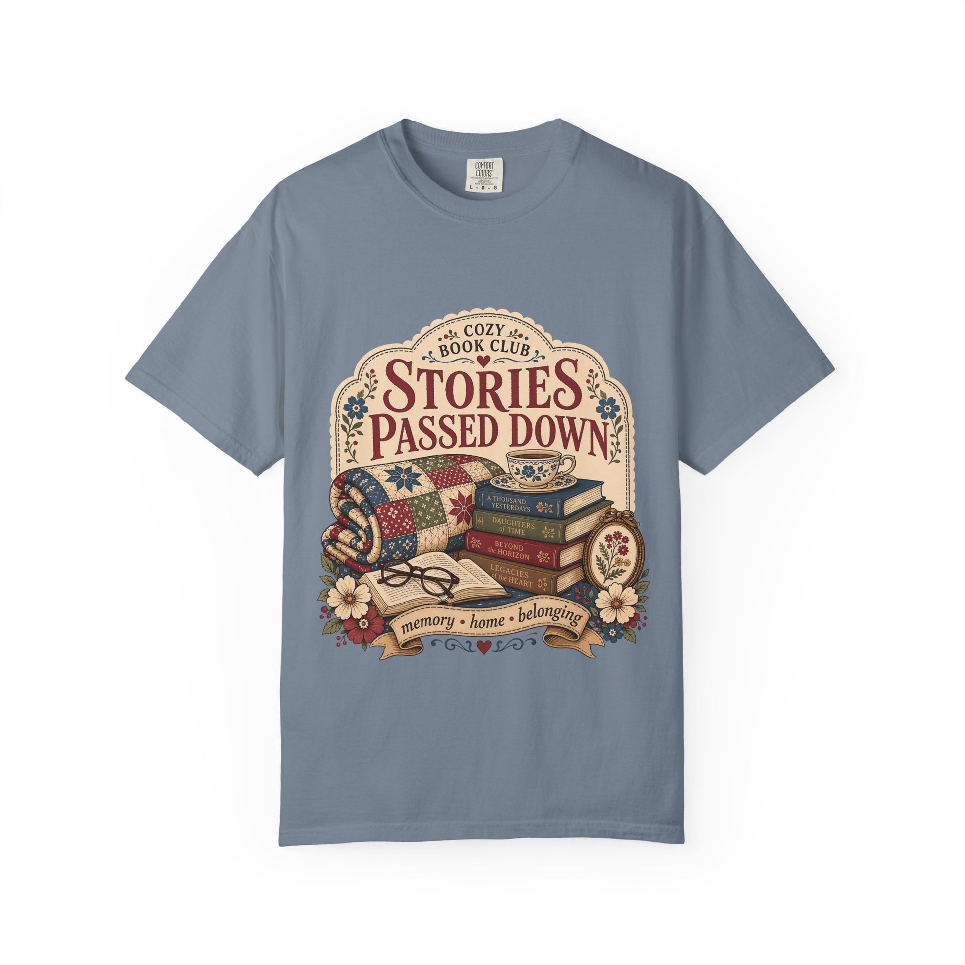 Stories Passed Down literary T-shirt with books, a patchwork quilt and floral keepsakes on Blue Jean.