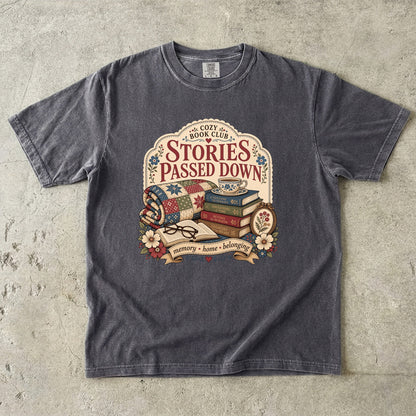 Stories Passed Down literary T-shirt with books, a patchwork quilt and floral keepsakes on Pepper.