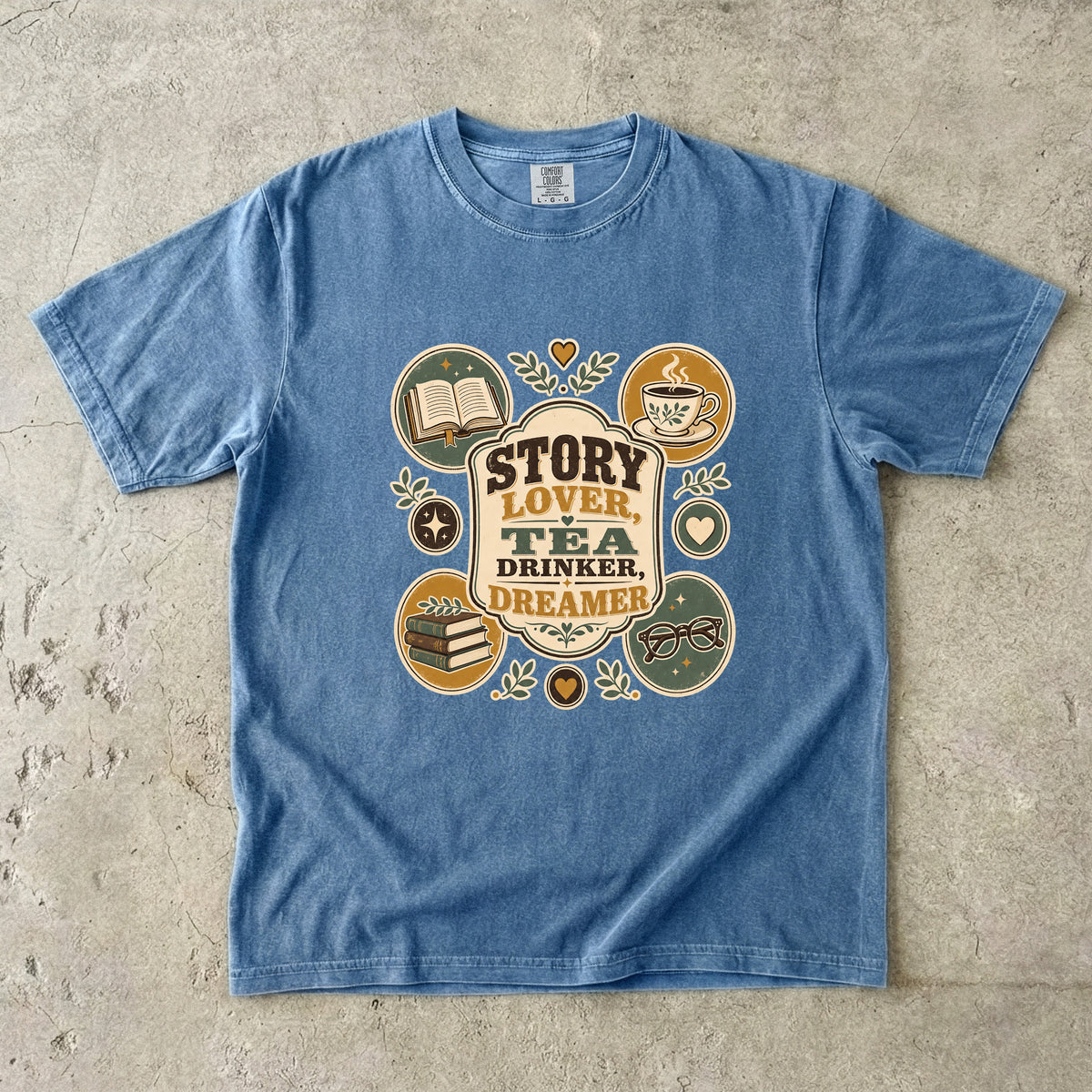 Story Lover Tea Drinker Dreamer book lover shirt in Blue Jean with books, teacup, glasses and leafy vintage details.