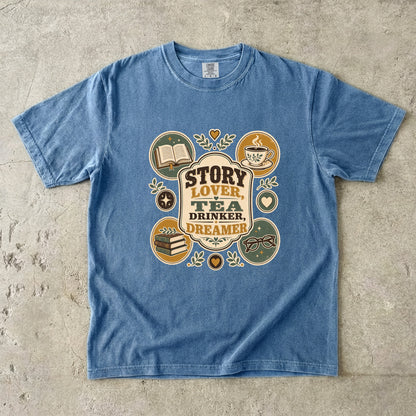 Story Lover Tea Drinker Dreamer book lover shirt in Blue Jean with books, teacup, glasses and leafy vintage details.