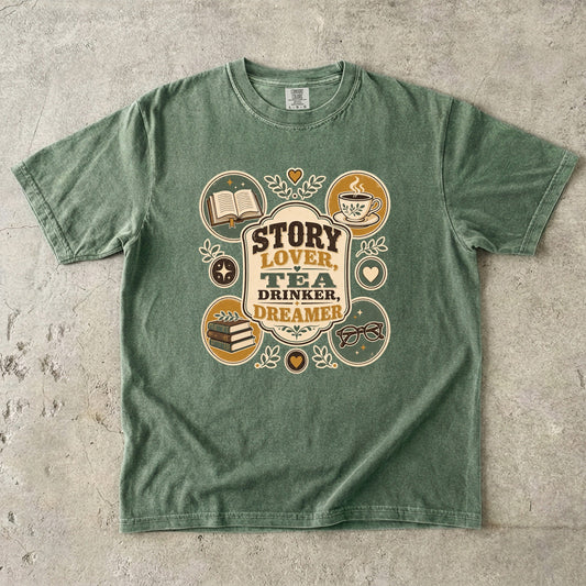 Story Lover Tea Drinker Dreamer book lover shirt in Moss featuring books, teacup, reading glasses and vintage emblems.