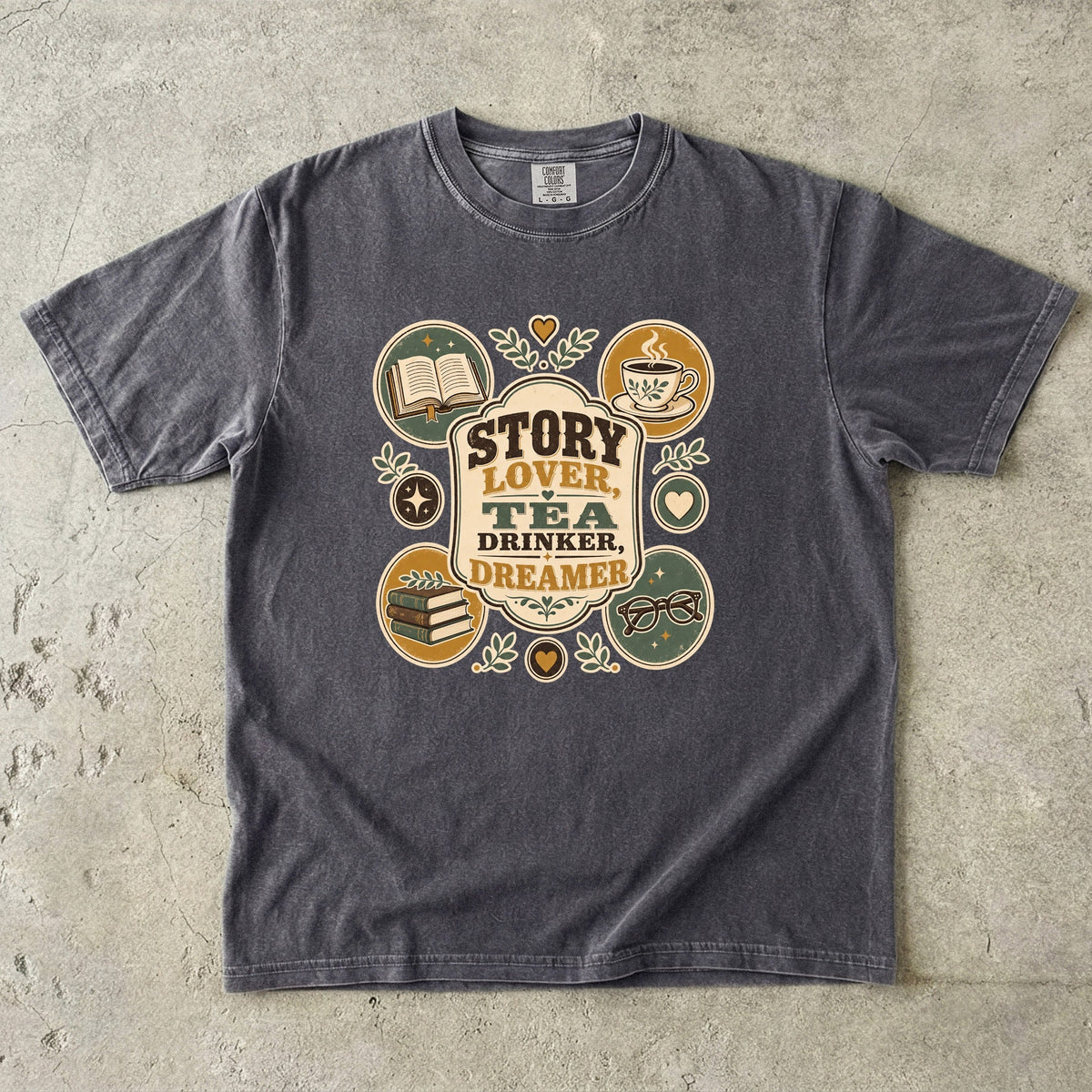 Story Lover Tea Drinker Dreamer book lover shirt in Pepper featuring a teacup, open book and reading-themed emblems.