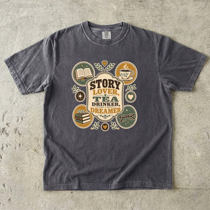 Story Lover Tea Drinker Dreamer book lover shirt in Pepper featuring a teacup, open book and reading-themed emblems.