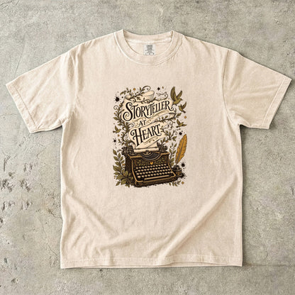 Storyteller at Heart writer shirt in Ivory featuring an ornate typewriter, manuscript ribbon, quill and botanical details.