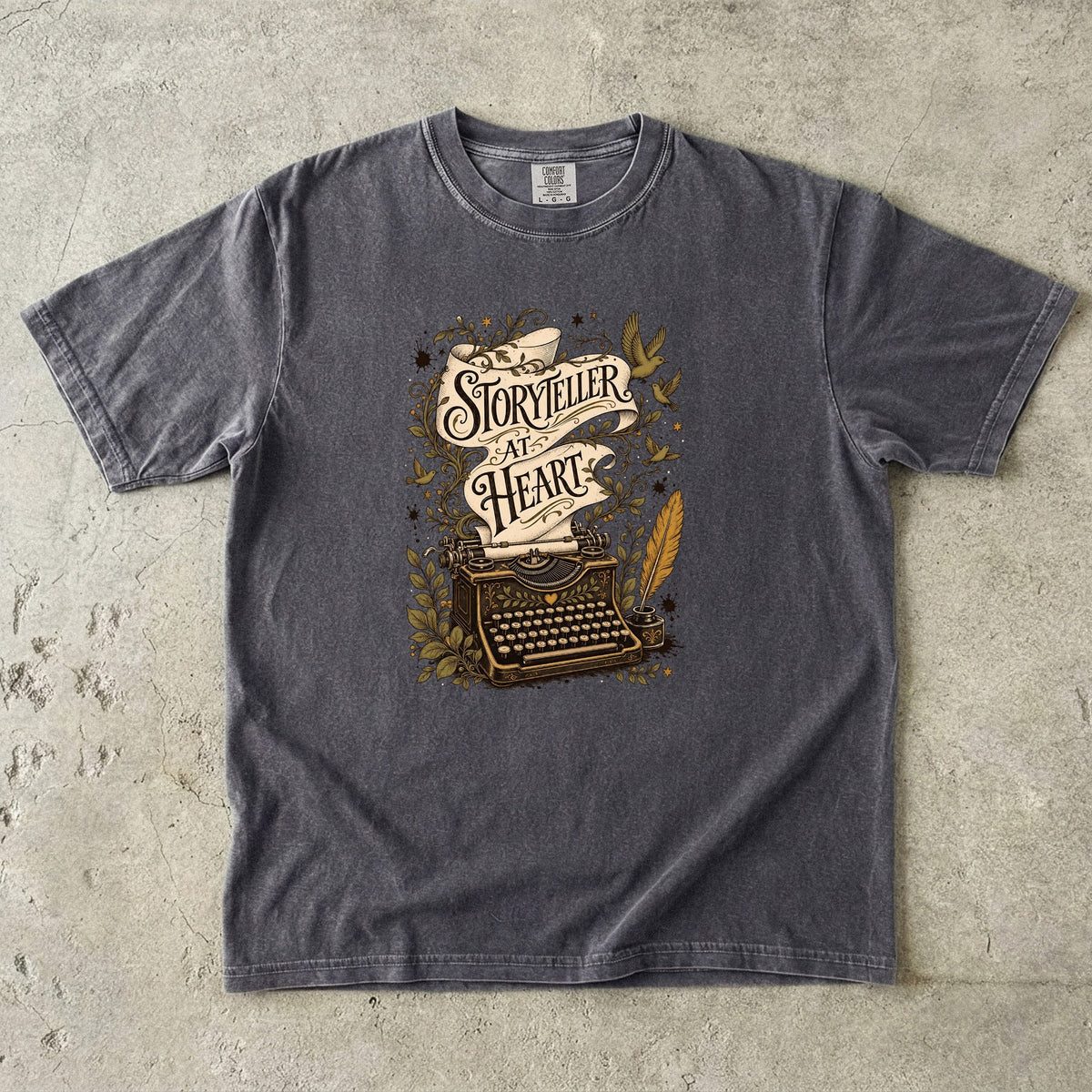Storyteller at Heart writer shirt in Pepper with an ornate vintage typewriter, manuscript scroll and literary botanical artwork.