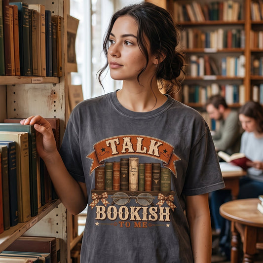 Talk Bookish to Me bookish T-shirt with vintage books, reading glasses, checked bows and Western-inspired literary artwork.
