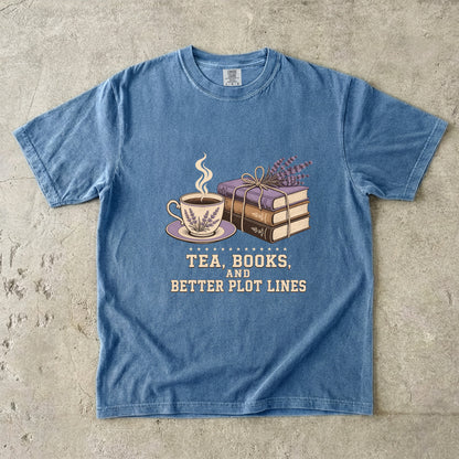 Blue Jean reading T-shirt featuring Tea, Books, and Better Plot Lines with stacked books, a steaming lavender teacup and lavender sprigs.