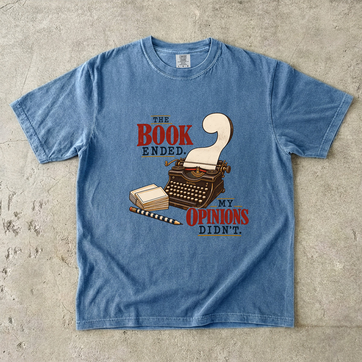 Blue Jean reader T-shirt with “The Book Ended. My Opinions Didn’t.” and a vintage typewriter illustration