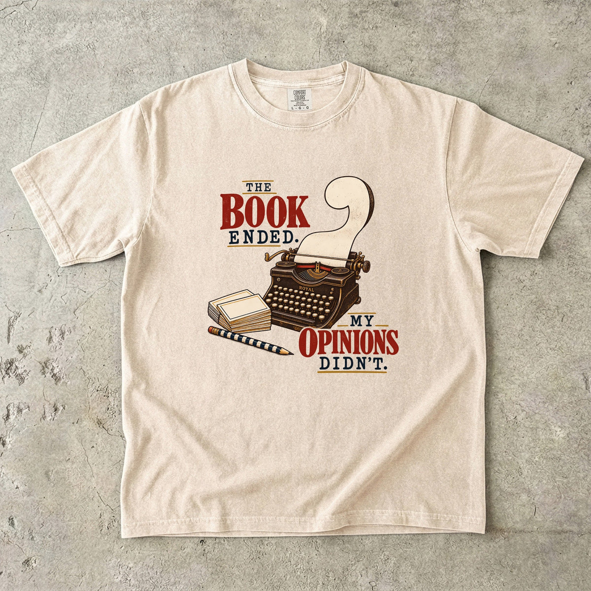 Ivory reader T-shirt with “The Book Ended. My Opinions Didn’t.” and a vintage typewriter illustration
