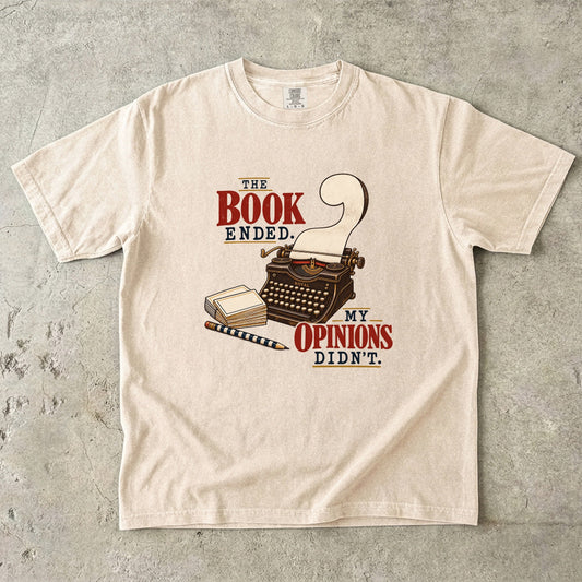 Ivory reader T-shirt with “The Book Ended. My Opinions Didn’t.” and a vintage typewriter illustration