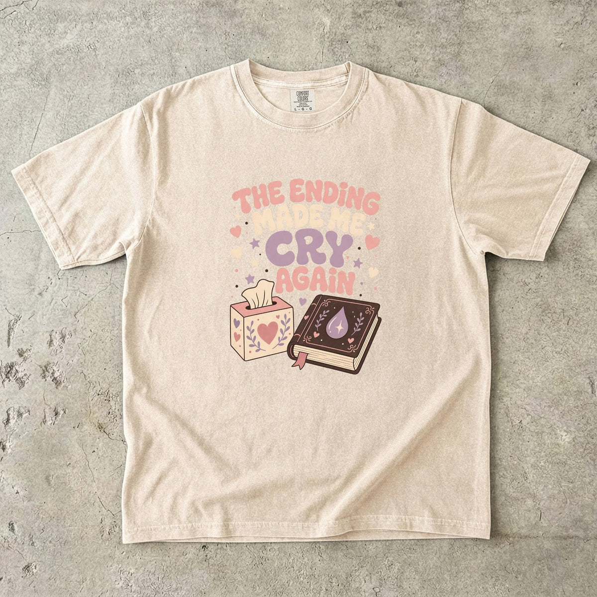 The Ending Made Me Cry Again funny reading shirt in Ivory with pastel hearts, stars, book and tissue box illustration.