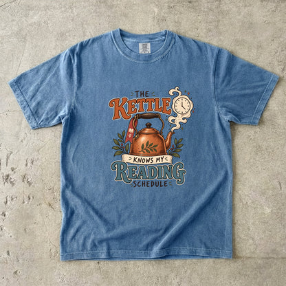 Blue Jean reading T-shirt with “The Kettle Knows My Reading Schedule” and an illustrated copper kettle