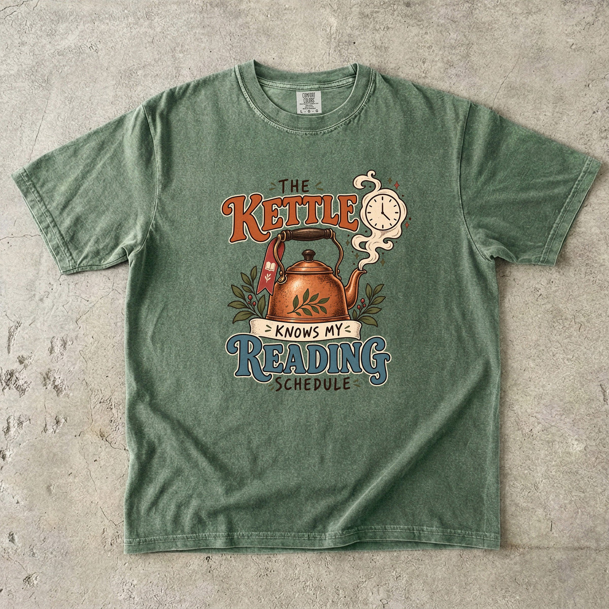 Moss reading T-shirt with “The Kettle Knows My Reading Schedule” and an illustrated copper kettle