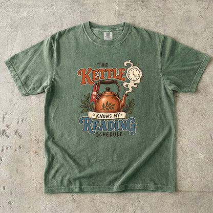 Moss reading T-shirt with “The Kettle Knows My Reading Schedule” and an illustrated copper kettle