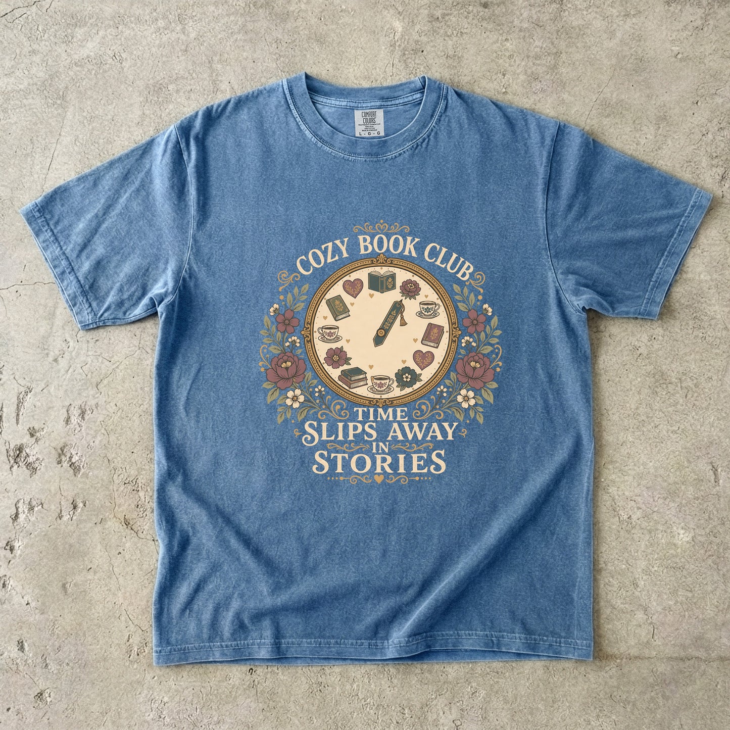 Time Slips Away in Stories book club T-shirt in Blue Jean featuring a vintage clock with books, teacups, hearts and flowers