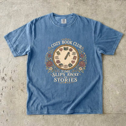 Time Slips Away in Stories book club T-shirt in Blue Jean featuring a vintage clock with books, teacups, hearts and flowers