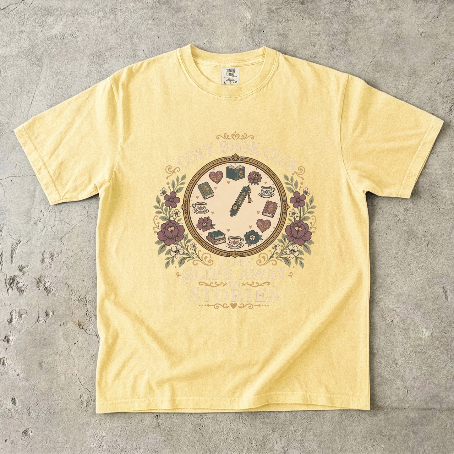 Time Slips Away in Stories book club T-shirt in Butter featuring a vintage clock with books, teacups, hearts and flowers