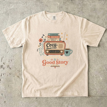 Front view of an Ivory Comfort Colors Book Lover T-shirt featuring the Tuned Into a Good Story artwork.