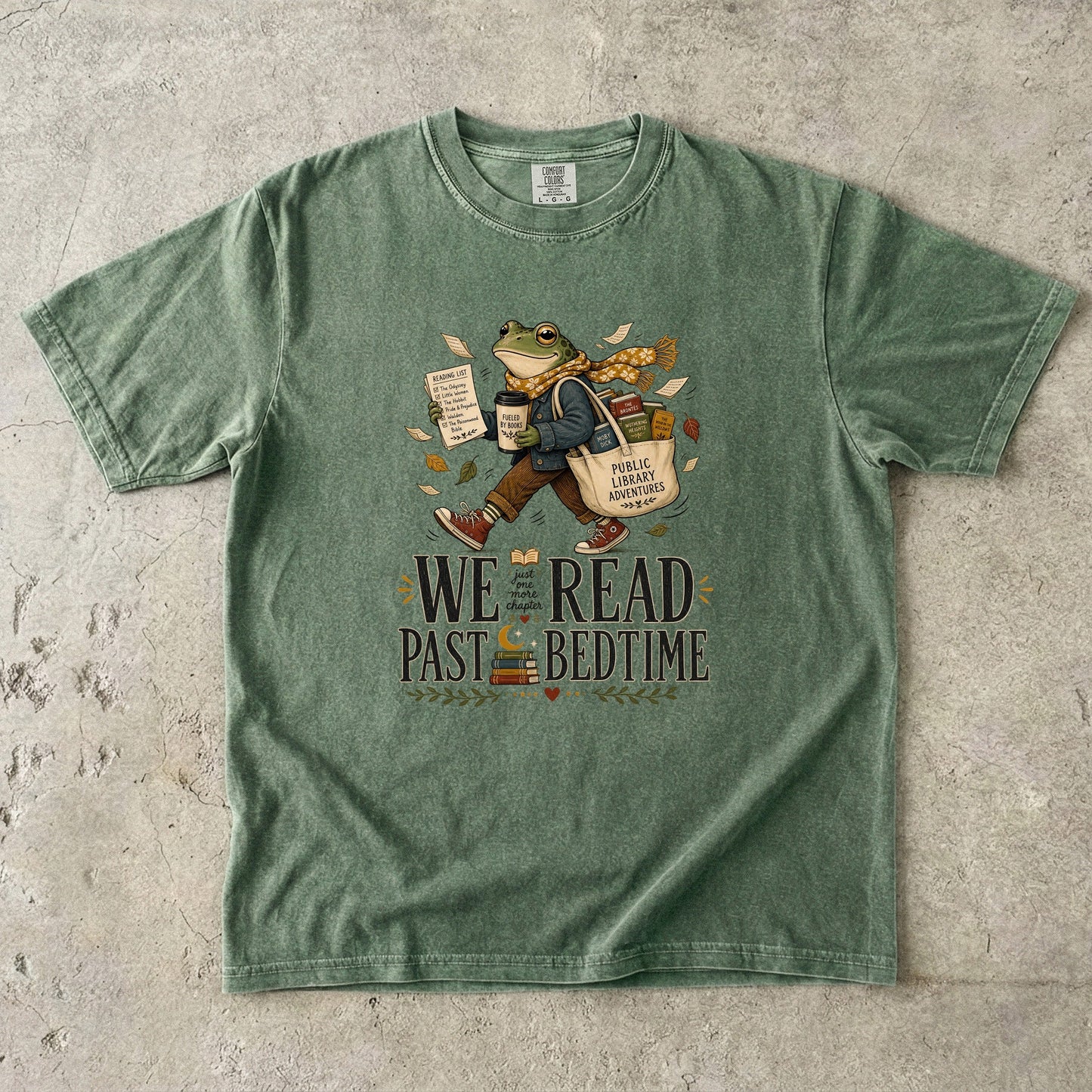 Moss Comfort Colors book lover T-shirt featuring a reading frog, stacked books and We Read Past Bedtime typography.