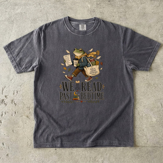 Pepper Comfort Colors We Read Past Bedtime bookish T-shirt featuring a vintage-style literary frog and books.