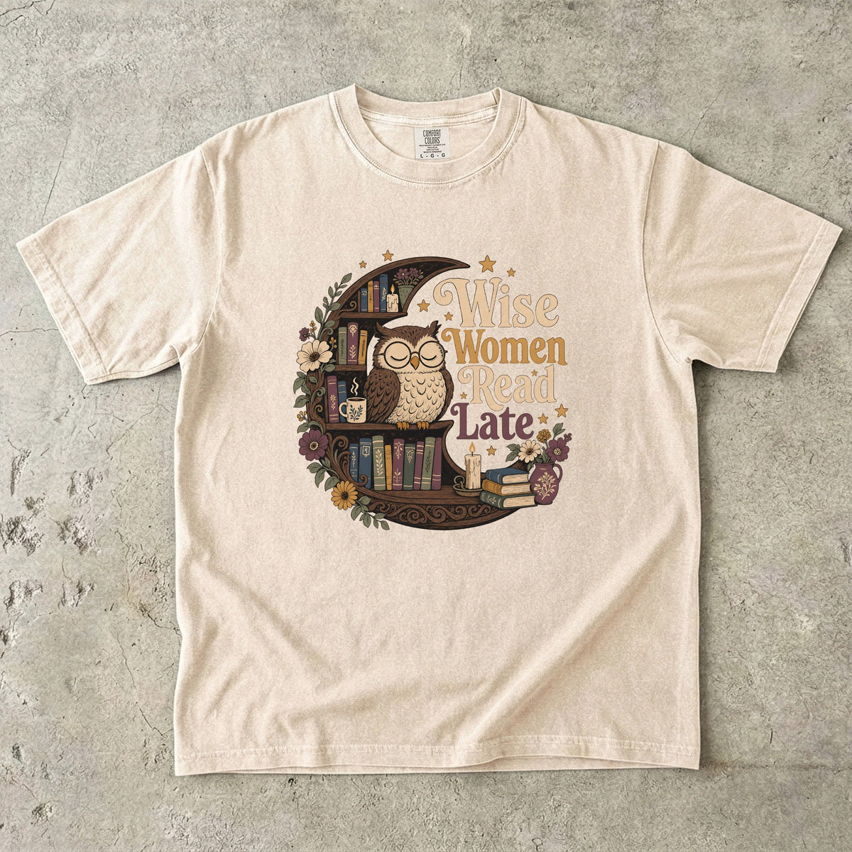 Wise Women Read Late night owl reading T-shirt in Ivory featuring an owl, crescent bookshelf, books, flowers and candles