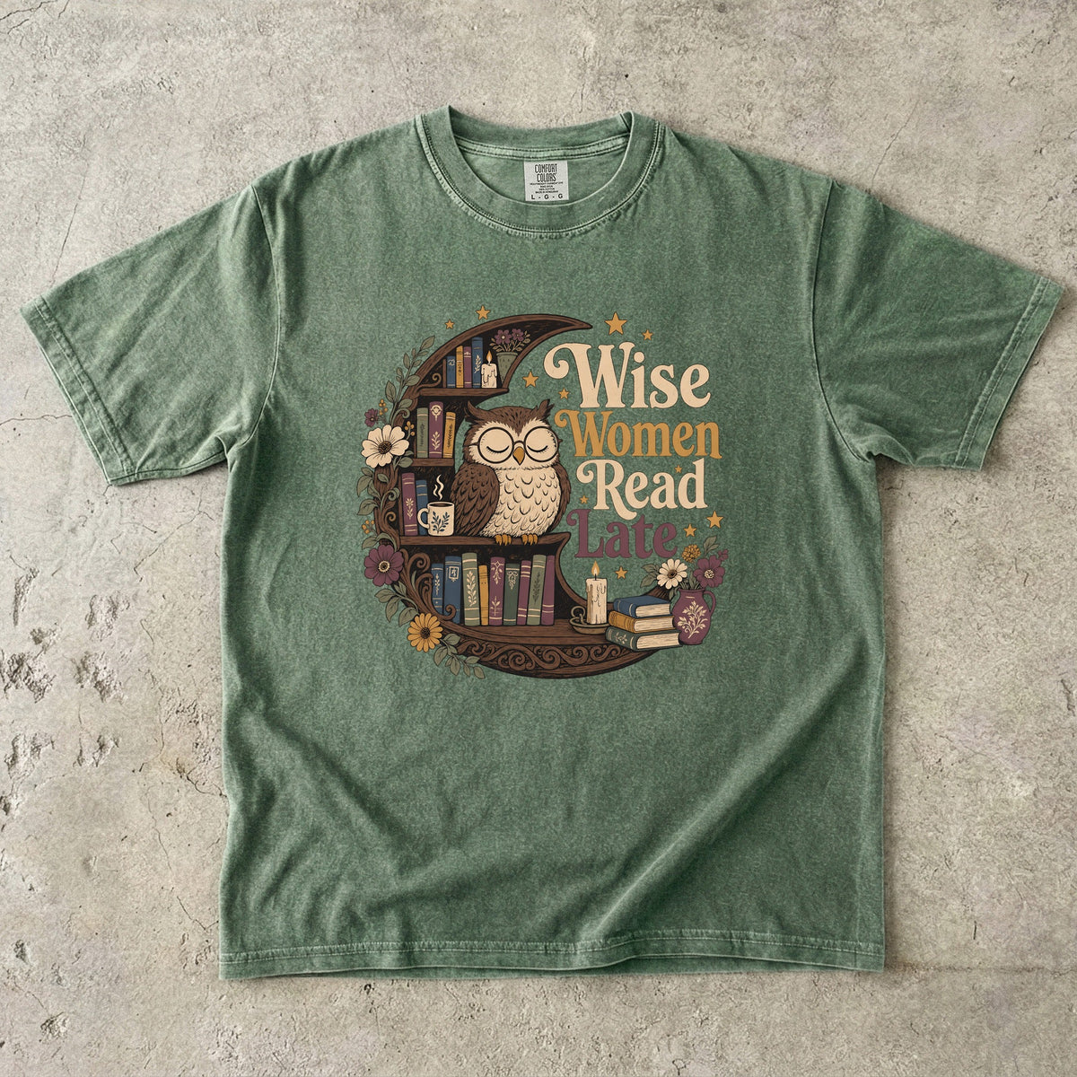 Wise Women Read Late night owl reading T-shirt in Moss featuring an owl, crescent bookshelf, books, flowers and candles