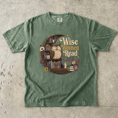 Wise Women Read Late night owl reading T-shirt in Moss featuring an owl, crescent bookshelf, books, flowers and candles